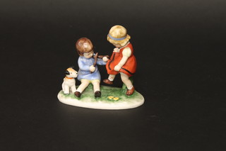 A Goebel figure of a seated boy with dog and dancing girl, the  base marked 1955 4 1/2"