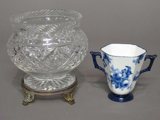 A circular cut glass vase 5", raised on a gilt metal base and a twin handled Royal Crown Derby blue and white cup 4"