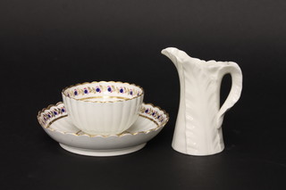 An 18th Century porcelain tea bowl and saucer and a Worcester leaf shaped jug, base with green mark and 12 dots 4"