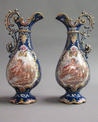A pair of Edwardian blue glazed pottery ewers decorated cherubs  12"