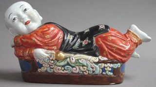 An Oriental porcelain figure of a reclining gentleman 14"