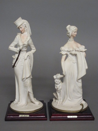 A pair of resin figures of ladies raised on wooden bases 11"
