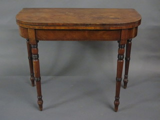A 19th Century mahogany D shaped card table, raised on turned supports 36"