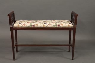 An Edwardian mahogany duet stool with upholstered seat and pierced fretwork panels to the sides, raised on square tapering  supports with H framed stretcher 38"