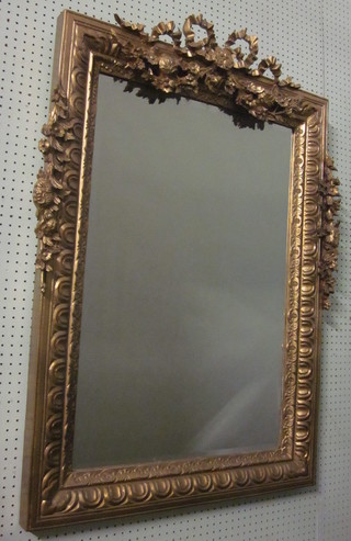 A pair of rectangular bevelled plate wall mirrors contained in decorative gilt frames with garlands to the top 46" x 30"