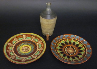 A brown salt glazed Art Pottery flagon with wooden spicket 10"  and 2 circular terracotta chargers 12"