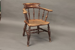 A 19th Century elm captains chair with spindle back
