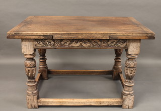 A carved oak drawleaf dining table, raised on turned and block supports 48"