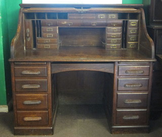 A Victorian oak kneehole roll top desk with well fitted interior  above 1 long and 8 short drawers 54"
