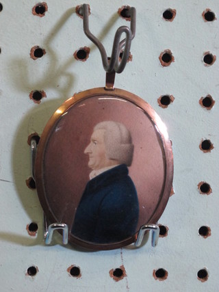 An 18th Century oval mourning portrait miniature "Standing Gentleman Wearing a Blue Coat" the reverse with woven hair   panel, contained in a gilt mount 3"