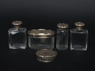 An oval glass dressing table jar with silver lid, do. pin jar, 2 rectangular scent bottles and a silver lid