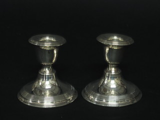 A pair of silver stub shaped candlesticks, marks rubbed, 3"