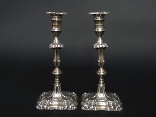 A pair of Victorian silver Rococo style candlesticks with detachable sconces, London 1898, some holes, 10"   ILLUSTRATED