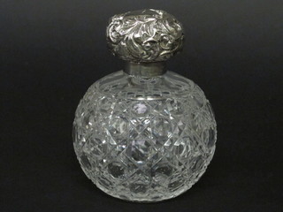 A circular Edwardian globular cut glass scent bottle with  embossed silver lid, Chester 1900, stopper missing, holes to lid,  5"