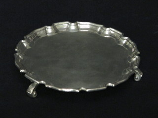 A circular silver salver with bracketed border, raised on 3 scroll feet, Birmingham 1926, Purchased at Harrods, 5 1/2 ozs
