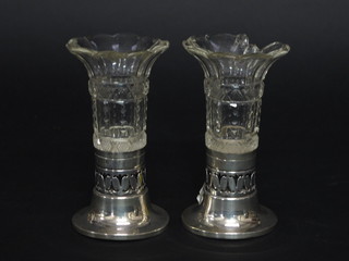 A pair of circular cut glass specimen vases raised on pierced silver bases, Birmingham 1905, 5", glass chipped,