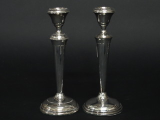 A pair of silver candlesticks 8", marks rubbed,