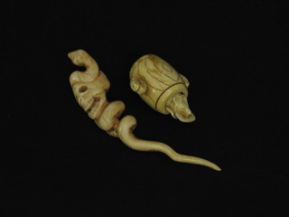 A carved ivory figure in the form of a skull with snake 5"  together with a carved ivory figure of a rat in a barrel