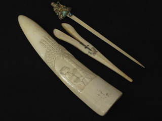 A carved ivory section of trunk decorated a figure 10", an  Oriental carved ivory pin decorated a figure of a Deity and a pair  of ivory glove stretchers