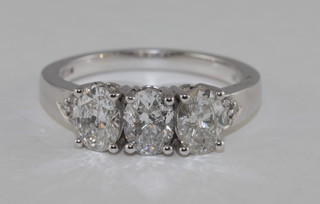 An 18ct white gold dress ring set 4 oval cut diamonds and set 2 diamonds to the shoulders, approx 1.62ct