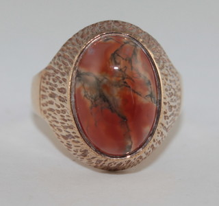 An 18ct gold dress ring set a cabouchon cut amber coloured stone