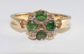 An 18ct yellow gold dress ring set emeralds and diamonds