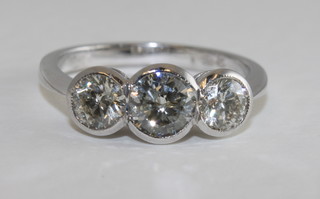 An 18ct white gold dress/engagement ring set 3 round brilliant cut diamonds