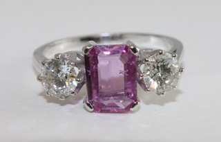 A lady's 18ct white gold dress ring set a pink rectangular cut sapphire surrounded by diamonds, approx 0.90/1.30ct