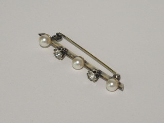 A gold brooch set white stones and pearls