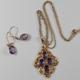 A gold pendant set oval amethysts hung on a gold chain together  with a pair of matching earrings