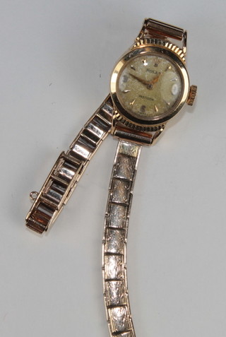 A lady's 1950's Rolex cocktail wristwatch contained in a 9ct gold case and with 9ct gold integral bracelet