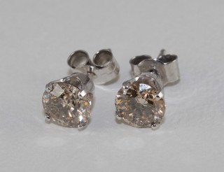 A pair of 14ct white gold diamond set ear studs, approx 1.50ct