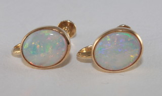 A pair of 9ct gold earrings set opals