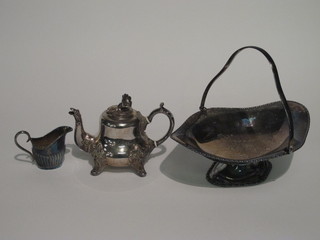 An oval silver plated boat shaped cake basket, a teapot and a jug