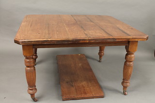 A Victorian mahogany extending dining table raised on turned  and reeded supports 49"