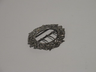 An oval pierced silver buckle decorated musical trophies 3"