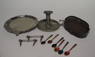A silver plated salver with bracketed border and armorial decoration, an oval silver plated tray, a pair of knife rests, a  chamber stick and 6 bronze and enamel coffee spoons