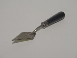 A Victorian silver bladed butter knife in the form of a trowel with turned ebony handle, London 1886