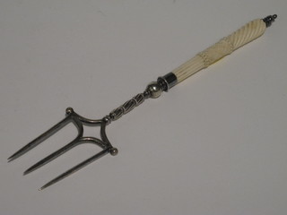 A silver plated toasting fork with carved ivory handle