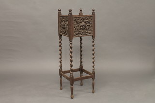 An Edwardian square carved oak jardiniere stand, raised on spiral turned supports 12"