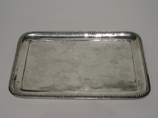 A rectangular white metal salver with various signatures and bead  work border