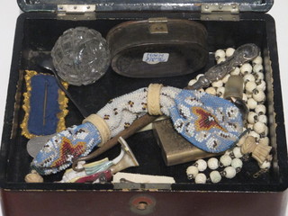 A lacquered box containing a small collection of costume jewellery