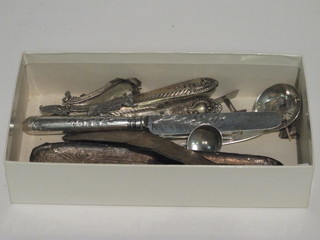 A silver caddy spoon, silver sifter spoon, teaspoon, butter knife and a small collection of scrap silver