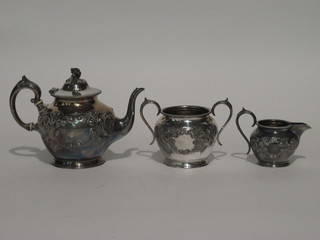 A circular 3 piece embossed Britannia metal tea service  comprising teapot, twin handled sugar bowl and cream jug