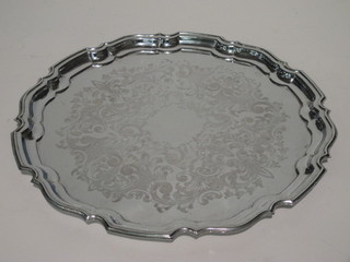 A circular silver plated engraved salver with bracketed border  16"