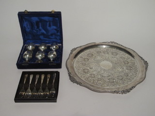 A circular engraved silver plated salver 14" and a set of 6 silver plated egg cups in a plush blue velvet box and 6 silver plated  pastry forks