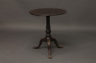 A 19th Century circular snap top mahogany tea table, raised on  pillar and tripod supports 23"