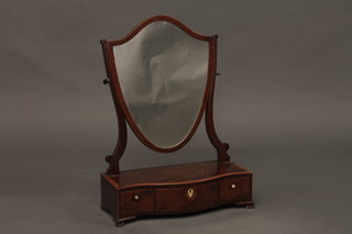 A Georgian shield shaped dressing table mirror contained in a  mahogany frame, the base of serpentine outline fitted 1 long and  2 short drawers, raised on bracket feet 17"