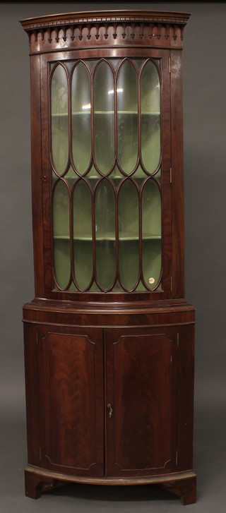 A Queen Anne style walnut double corner cabinet, the upper section with moulded and dentil cornice the interior fitted shelves  enclosed by astragal glazed panelled doors, the base fitted a  cupboard enclosed by panelled doors, raised on bracket feet 24"