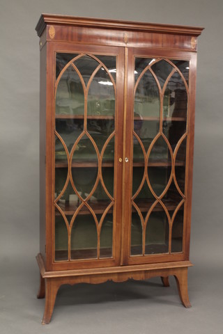 A Georgian inlaid mahogany bookcase with moulded cornice, the shelved interior enclosed by astragal glazed panelled doors, raised  on splayed bracket feet 37"